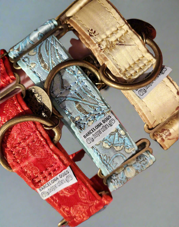 Dog collars with decorative clasps and 'Barcelona Dogs' branding on a gray background